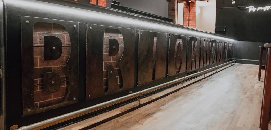 Custom metal BRICKHOUSE lettering mounted on a wall