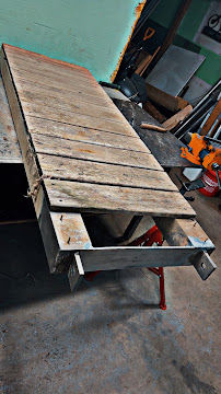 Steel table frame with reclaimed wood top under fabrication